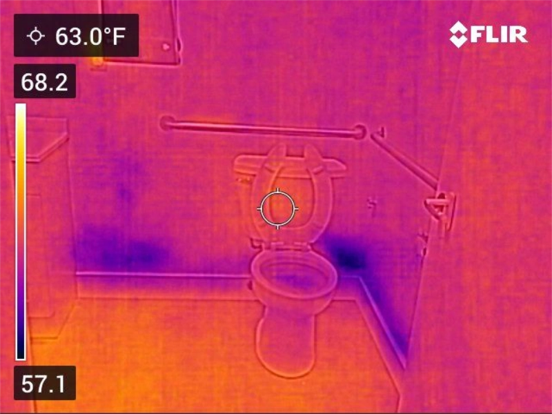 The Silent Saboteurs: 5 Hidden Water Sources Creating Mold in Your Home 1 Thermal image of a bathroom showing cool spots at the base of the wall near the toilet, a sign of hidden moisture